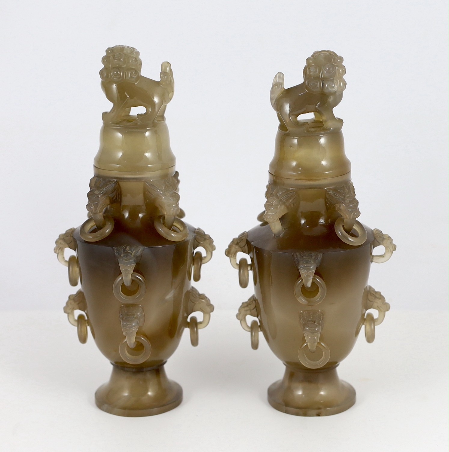 A pair of Chinese agate vases and covers, early 20th century, 19.5cm high, chip to one lion